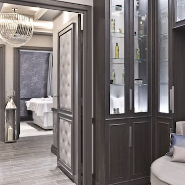 A modern bathroom with a large mirror, a vanity, and a chandelier.