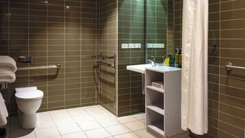 A modern bathroom with a toilet, sink, and shower area.