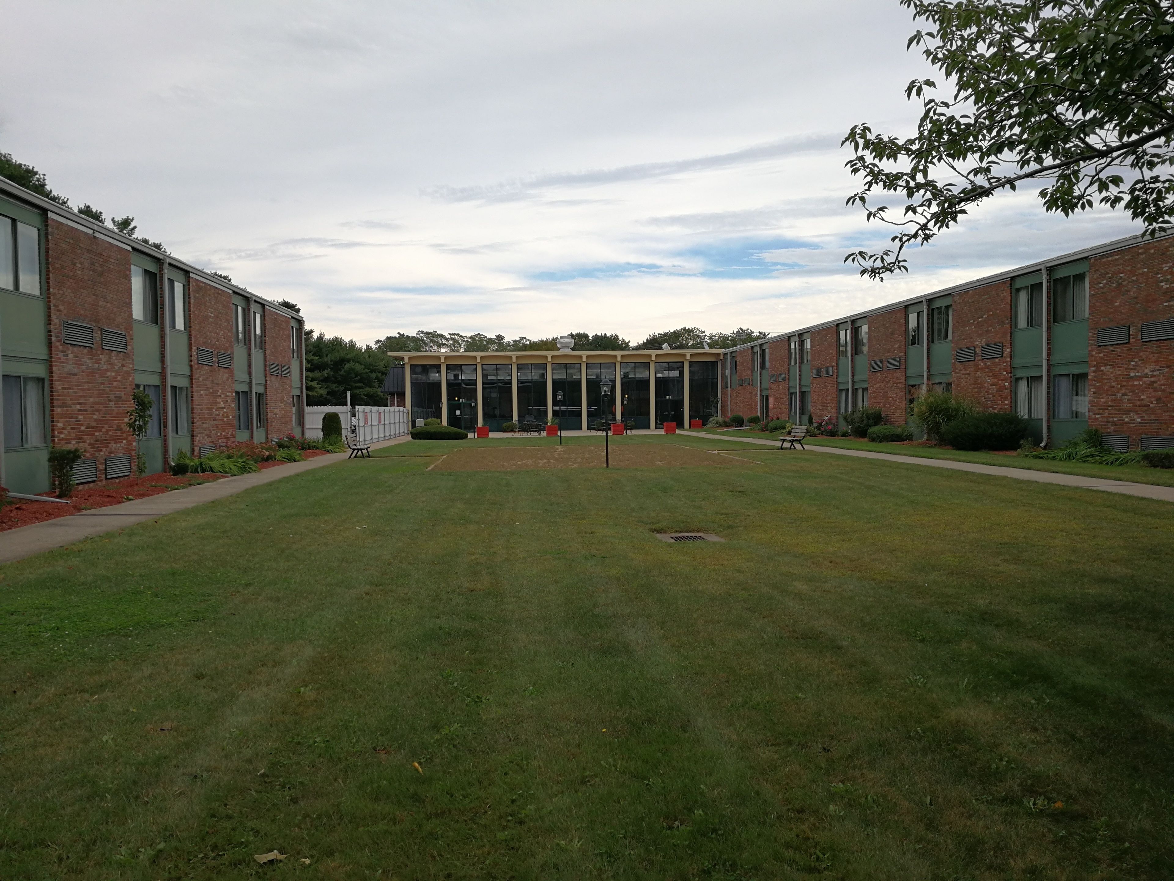 A building with a central courtyard, surrounded by brick walls and large windows.