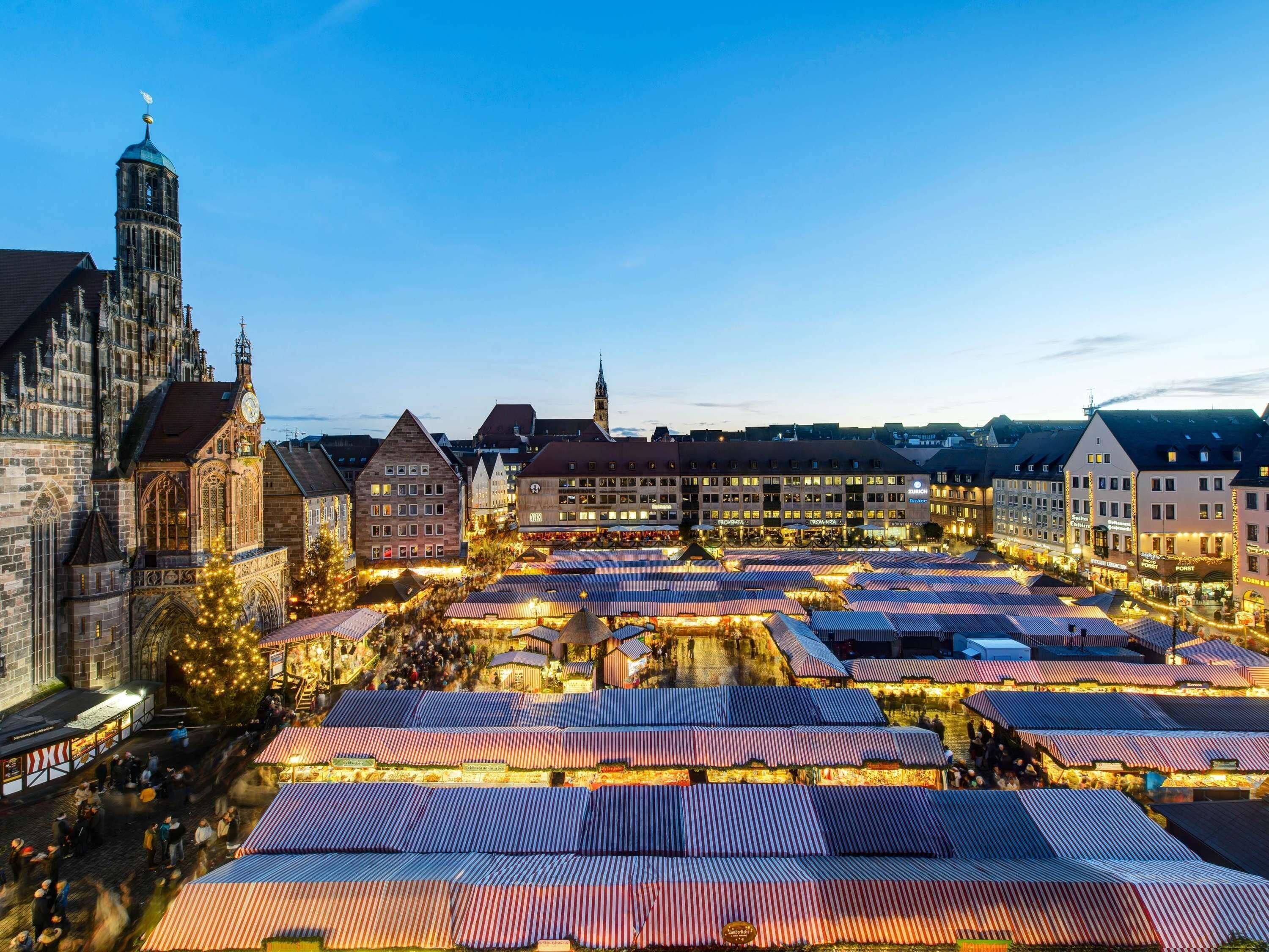 A historic town square with traditional buildings and a prominent church tower.