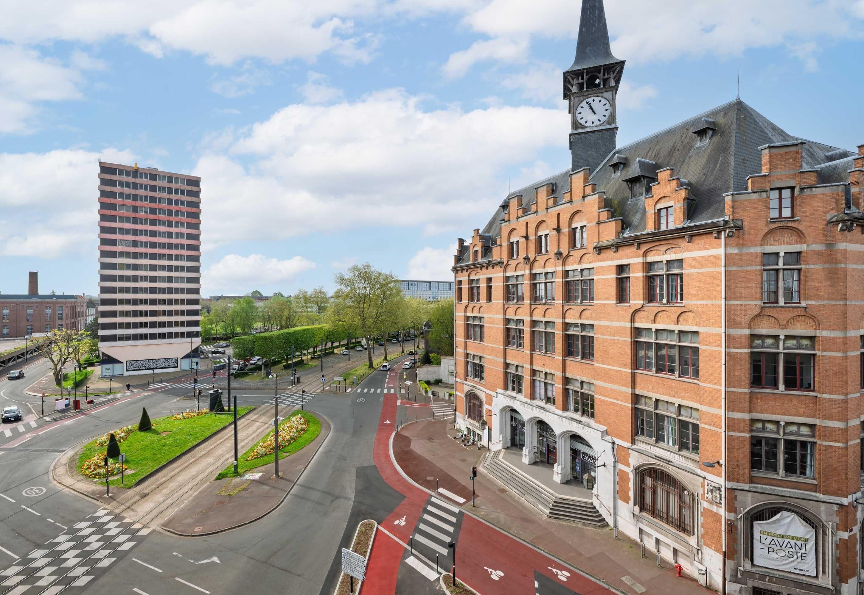 A street view with a historic building, a modern high-rise, and a clock tower.