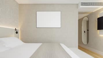 A modern hotel room with a large bed, a mounted TV, a wall-mounted mirror, and a blank framed picture.