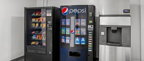 A vending machine area with a Pepsi machine, a water dispenser, and a snack vending machine.