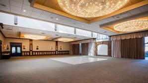 A spacious hall with a high ceiling, large chandeliers, and a polished floor. - Days Inn & Suites by Wyndham Rochester Hills MI (Rochester)