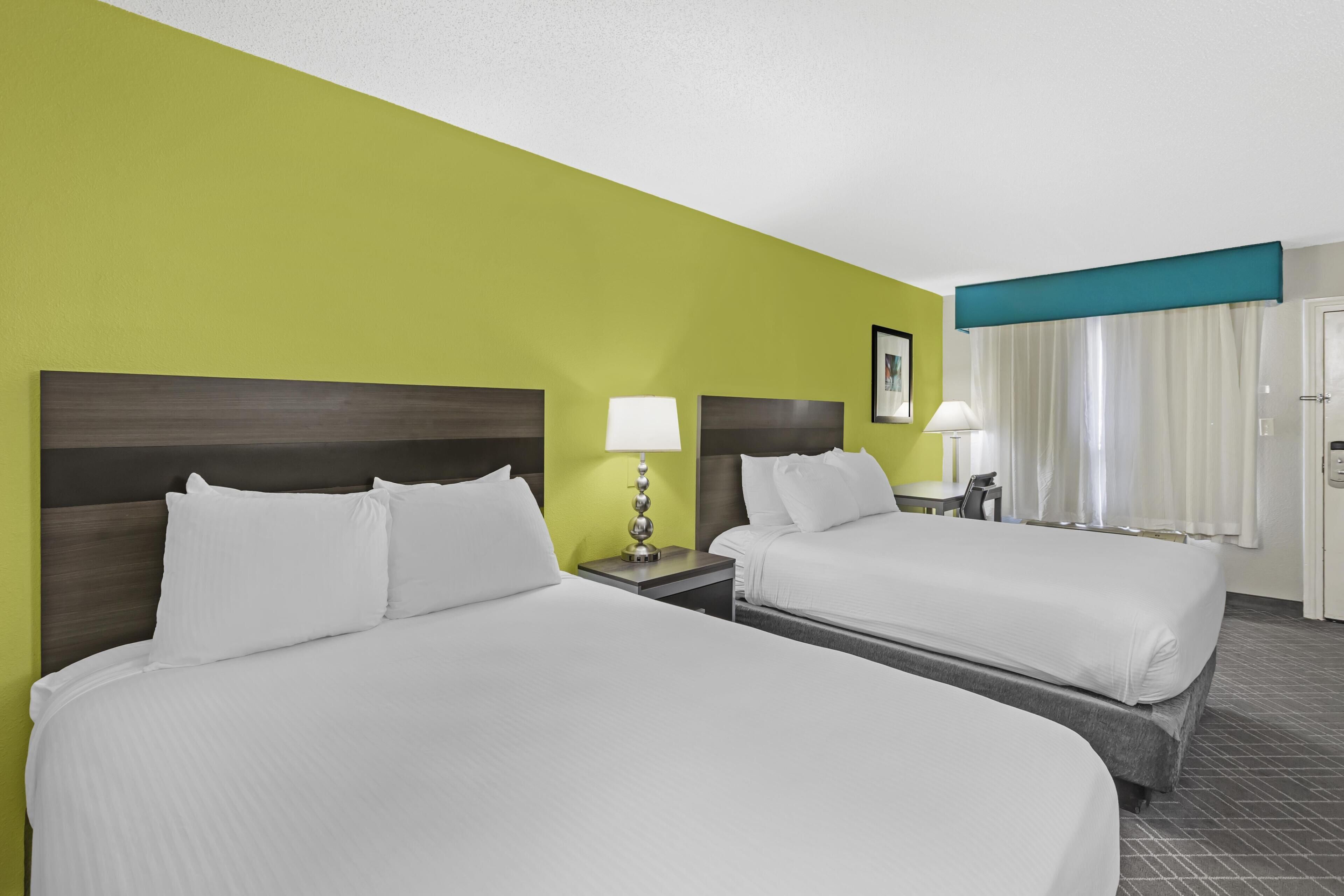 Premium bedding, pillow-top beds, laptop workspace, soundproofing