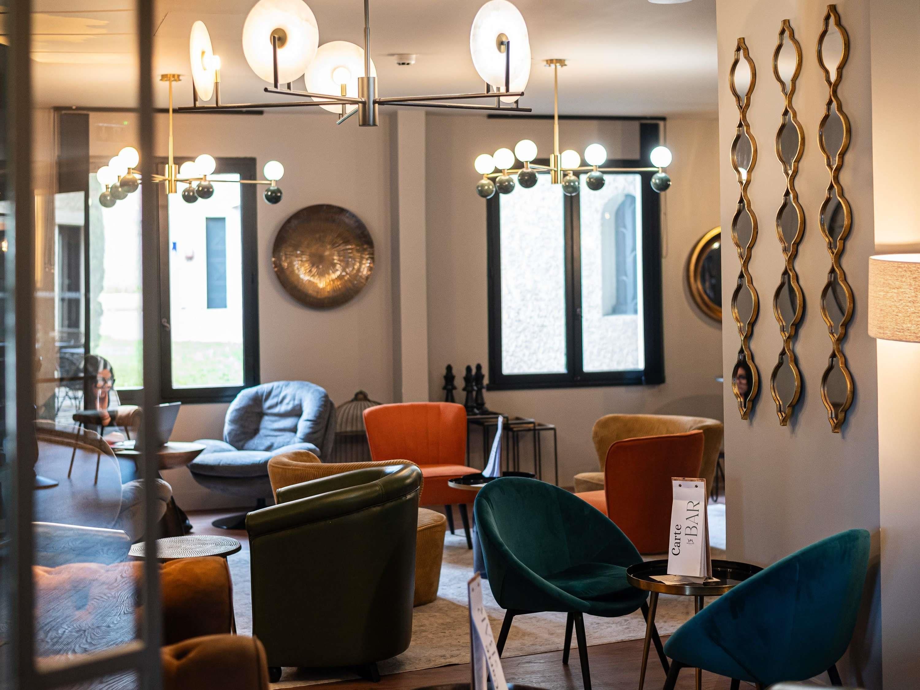 A modern interior with multiple seating areas, a bar area, and decorative wall art.