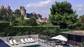 Seasonal outdoor pool, open 9:00 AM to 8:30 PM, pool umbrellas