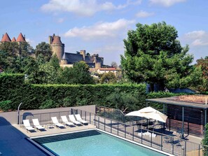 Seasonal outdoor pool, open 9:00 AM to 8:30 PM, pool umbrellas