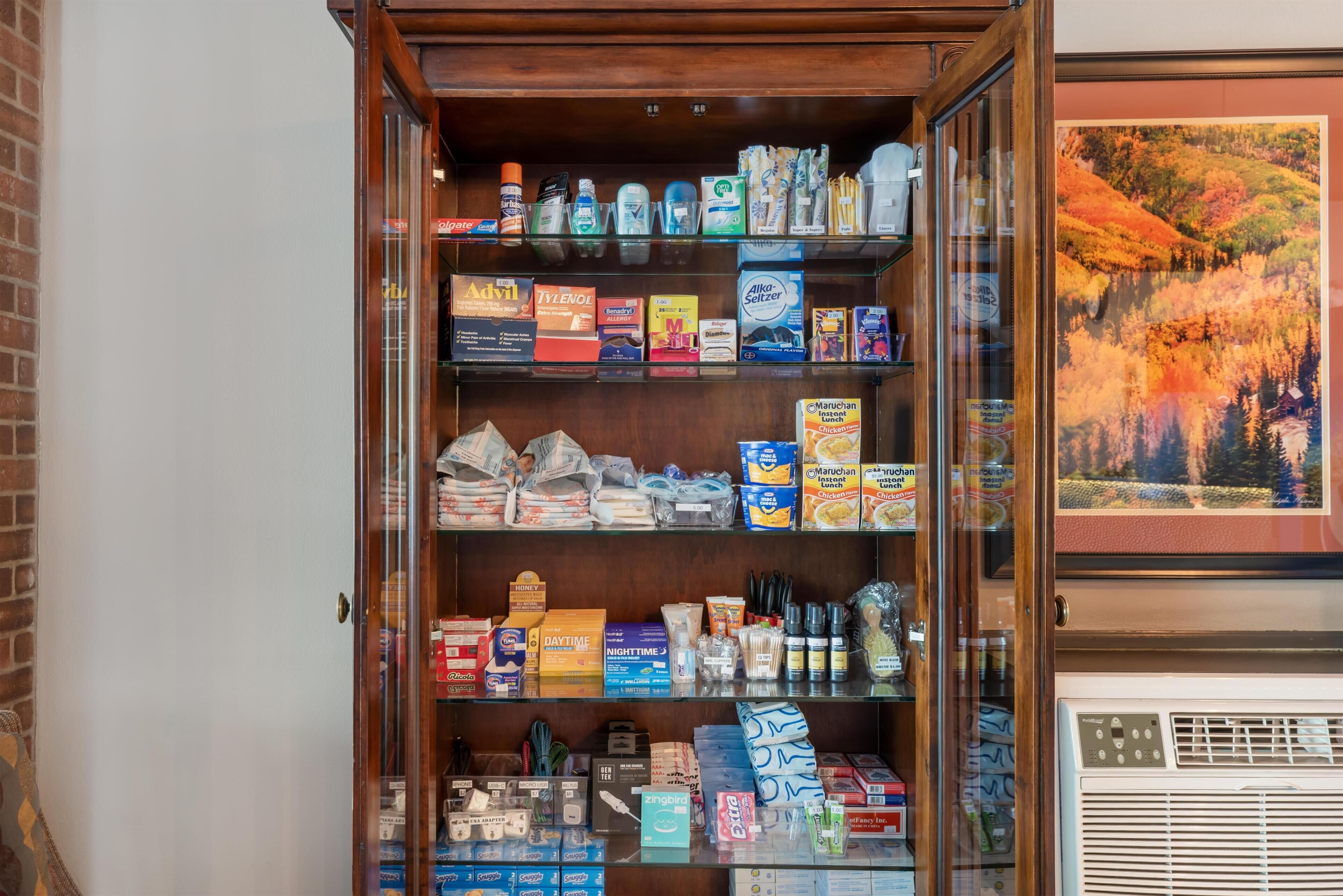 A display cabinet with various household items and products.