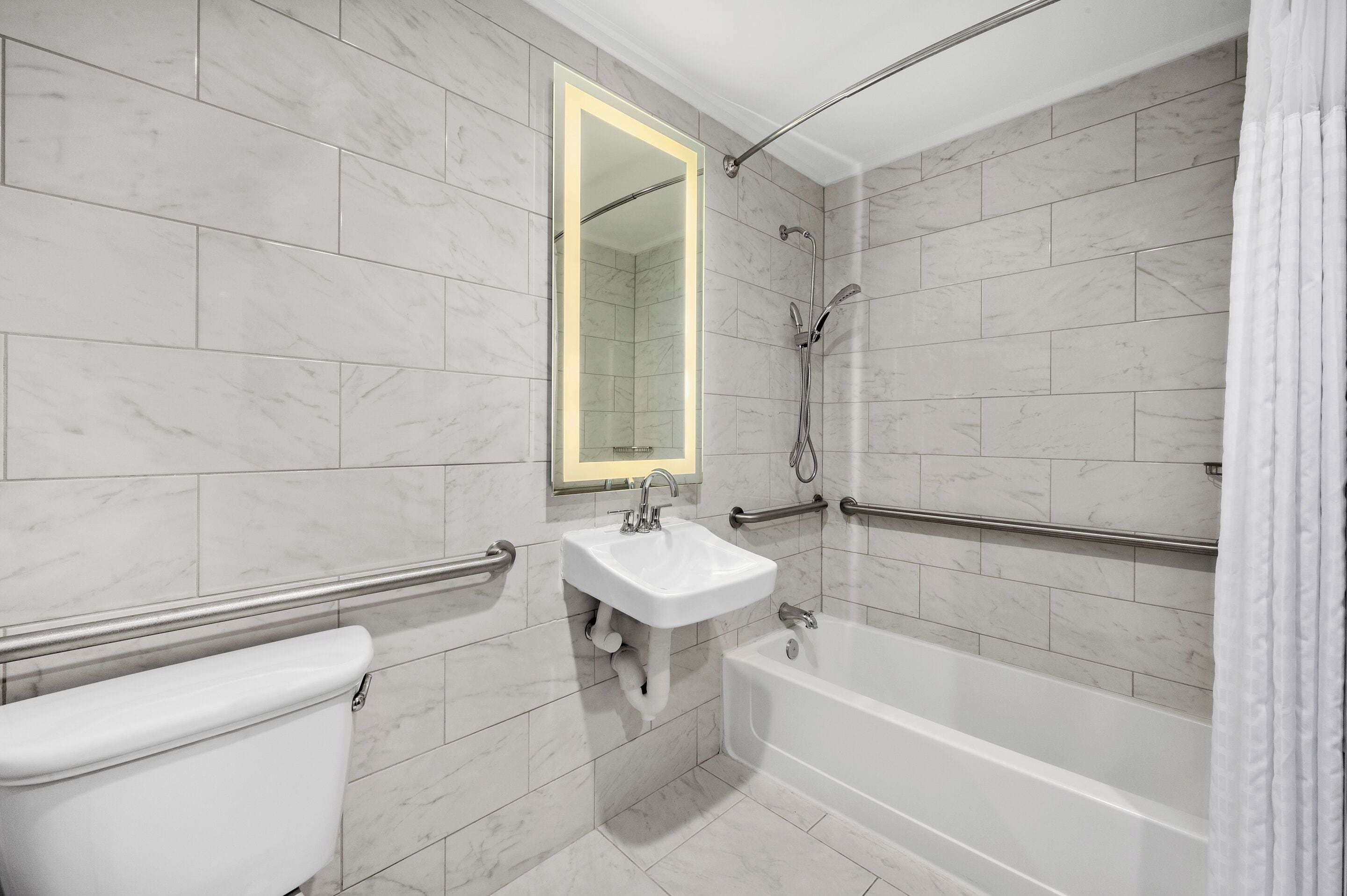 room, 1 king bed, bathtub grab bars | bathroom | designer toiletries, hair dryer, towels