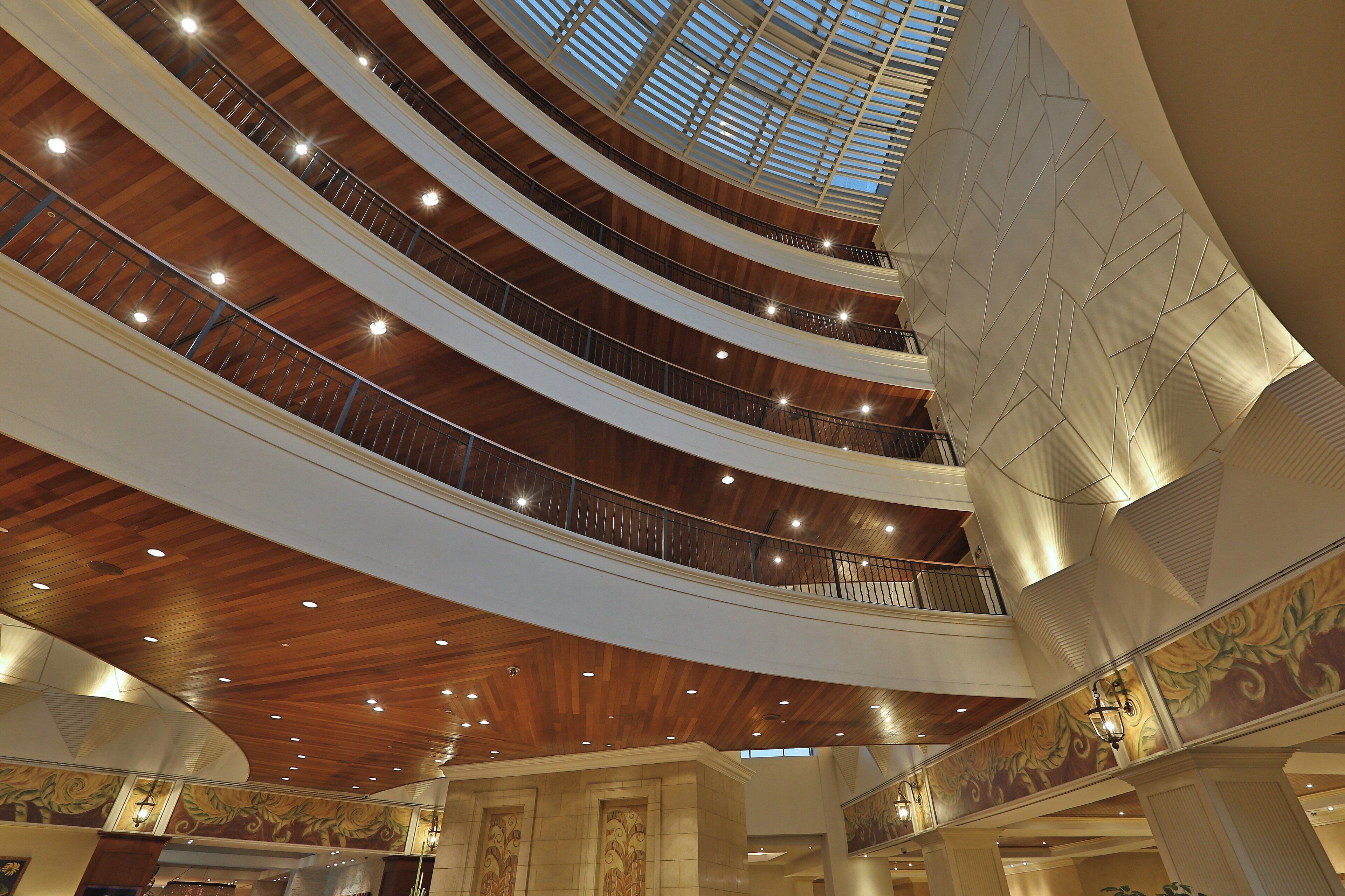 A multi-level atrium with a wooden ceiling and a skylight.