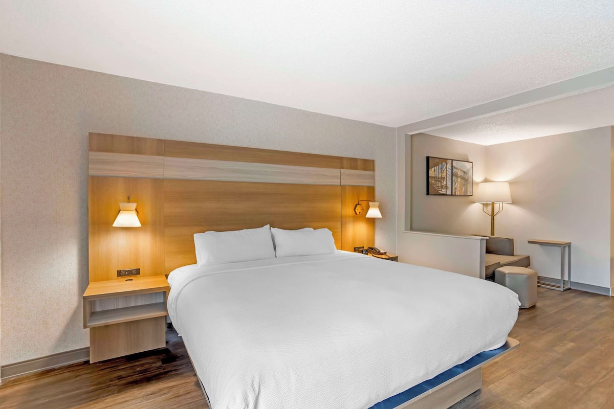 Premium bedding, desk, laptop workspace, blackout drapes