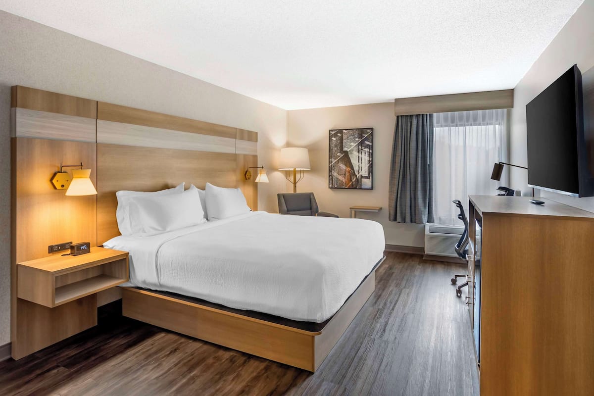 Premium bedding, desk, laptop workspace, blackout drapes