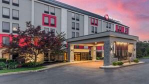 A hotel with a modern facade, a prominent entrance, and a sign indicating it is part of the Best Western Plus chain.