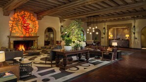 A lobby with a fireplace, seating area, and a reception desk. - Fairmont Sonoma Mission Inn & Spa (Sonoma)