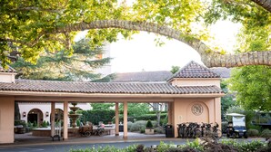A covered outdoor area with a fountain, seating, and bicycles parked. - Fairmont Sonoma Mission Inn & Spa (Sonoma)