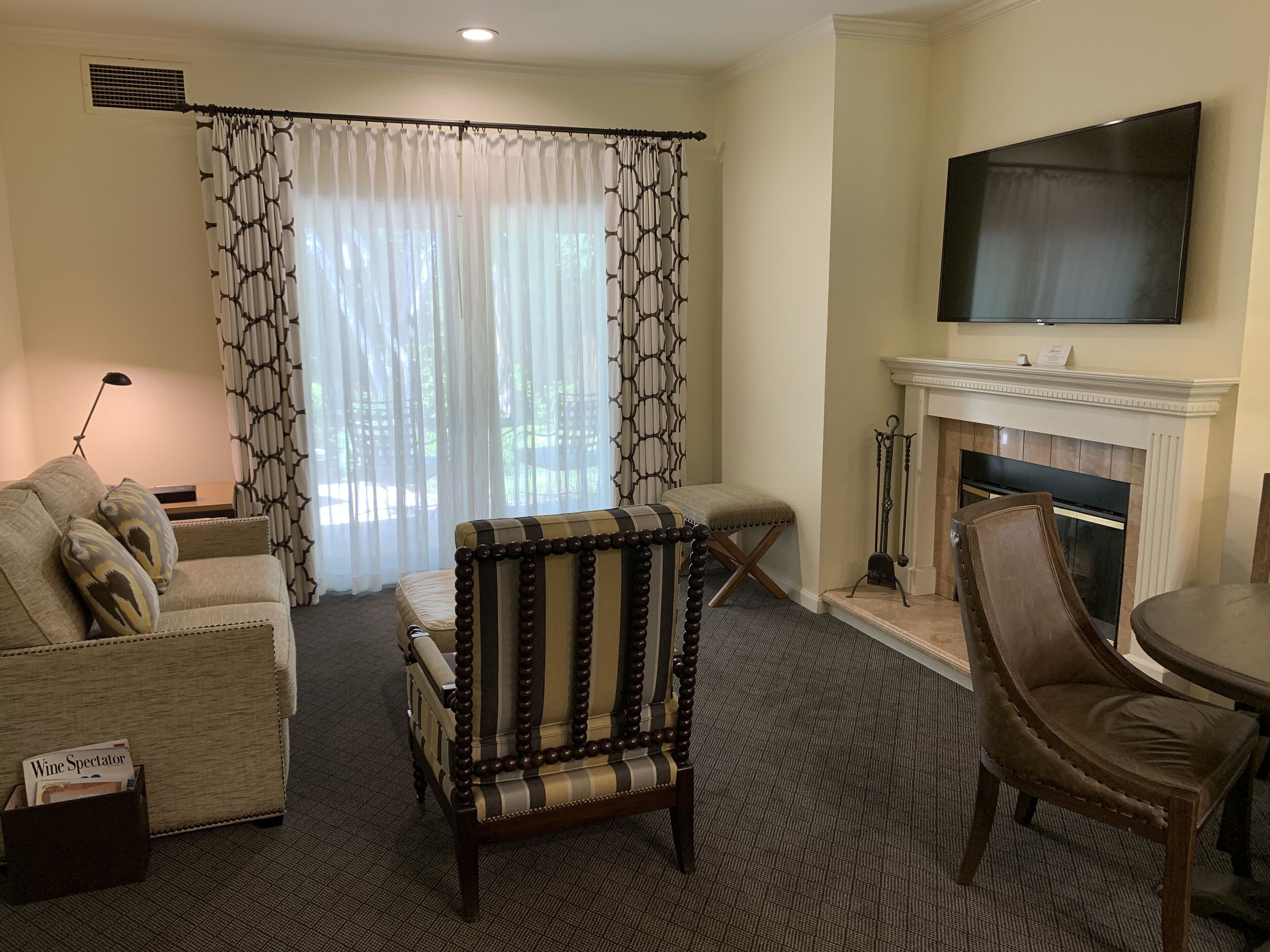 A living room with a sofa, armchair, and a fireplace.