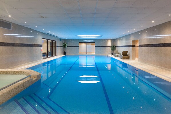 A large indoor swimming pool with clear blue water, tiled walls, and a modern design. - Best Western Plus The Connaught Hotel & Spa (Bournemouth)