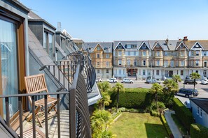 A residential building with a balcony, a small garden, and a street view with parked cars. - Best Western Plus The Connaught Hotel & Spa (Bournemouth)