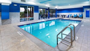 An indoor swimming pool with clear water, a tiled floor, and a pool ladder. - Hampton Inn & Suites Houston Heights I-10 (Houston)
