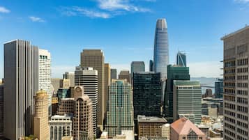 A cityscape with a variety of high-rise buildings, including a prominent skyscraper with a unique design.