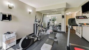 A gym with various exercise equipment, a bench, and a treadmill. - Quality Inn Easton (Easton)