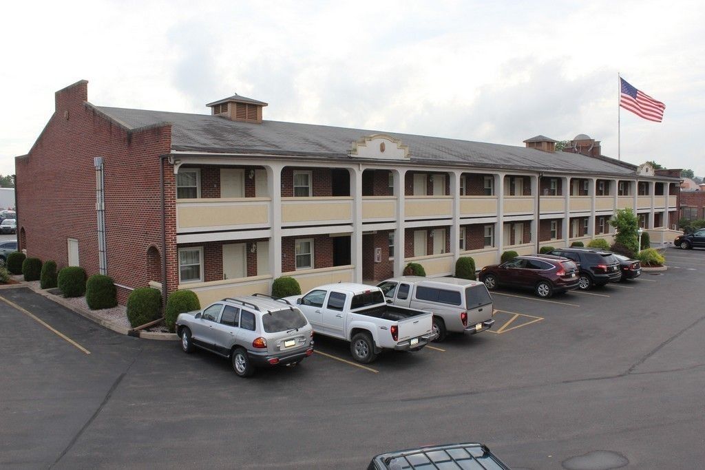 A multi-story motel with a parking lot.