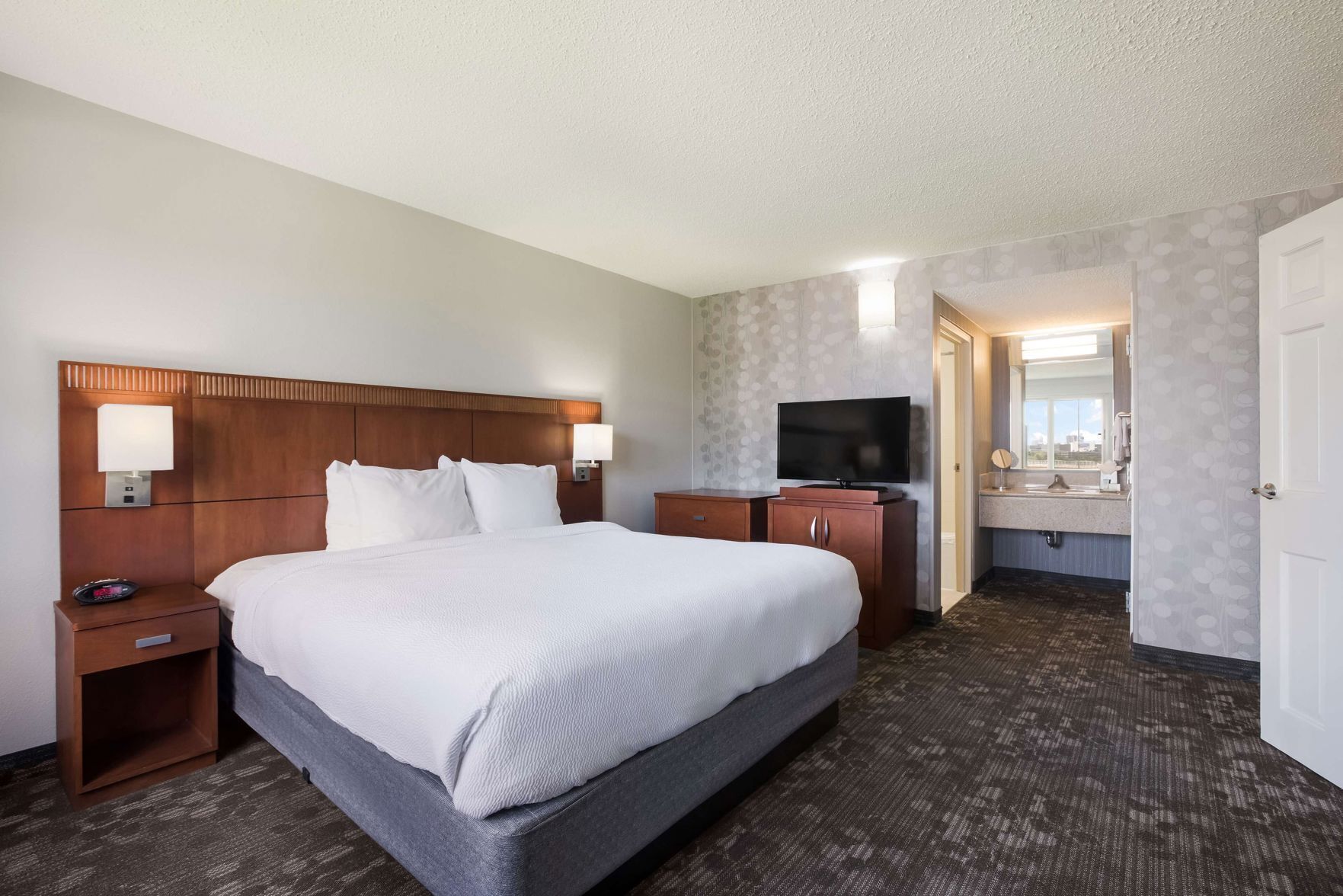 Premium bedding, desk, laptop workspace, blackout drapes