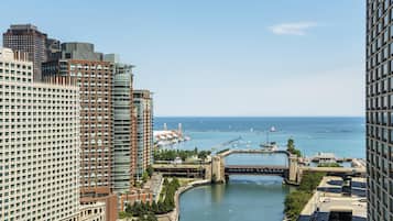 A high-rise hotel with a view of a river and marina.