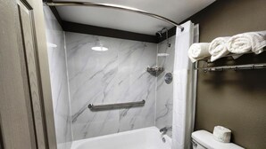 A bathroom with a bathtub, toilet, and shower. - Baymont by Wyndham Lafayette (Lafayette)