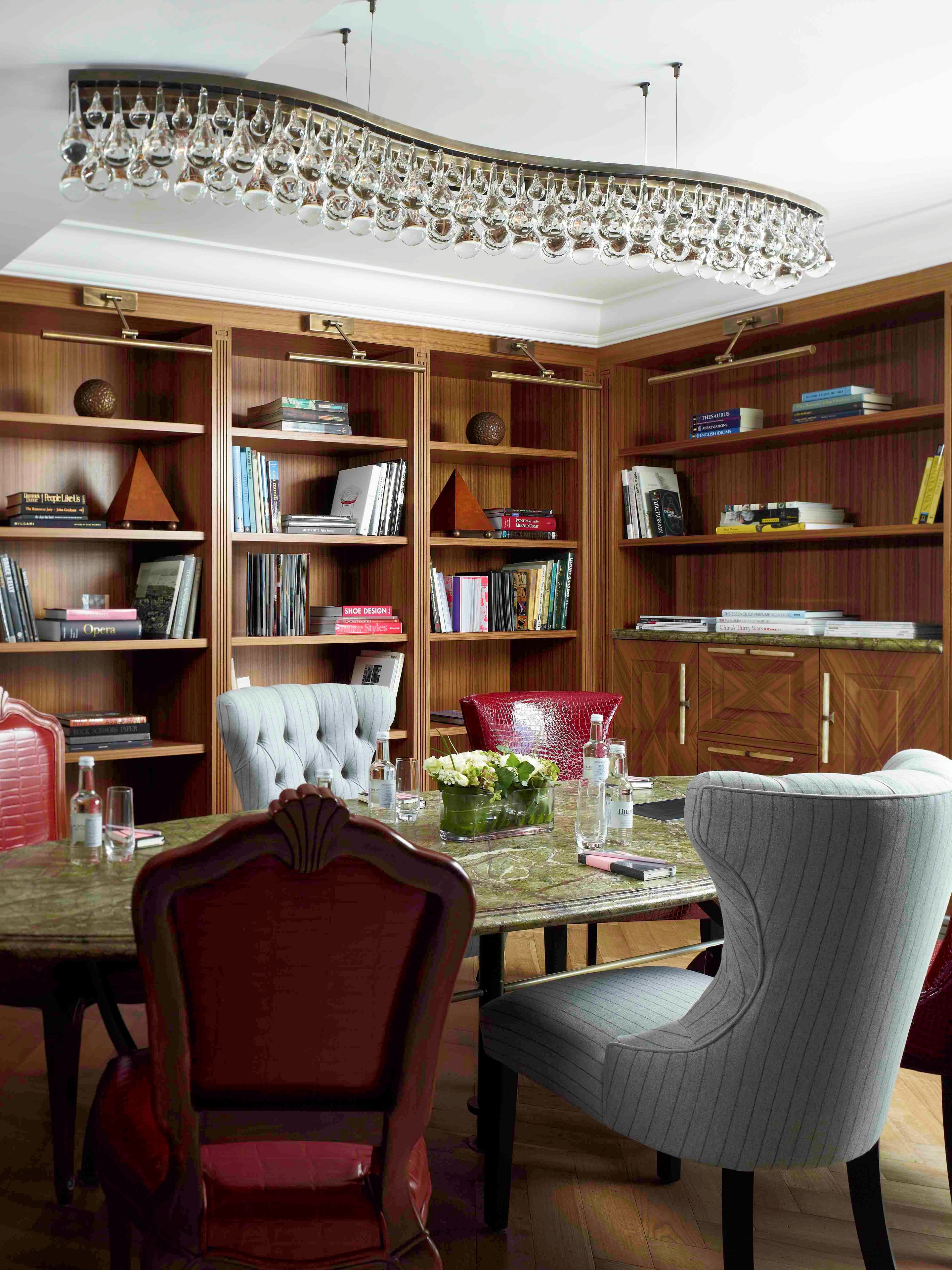 A library with bookshelves, a dining table, and chairs.