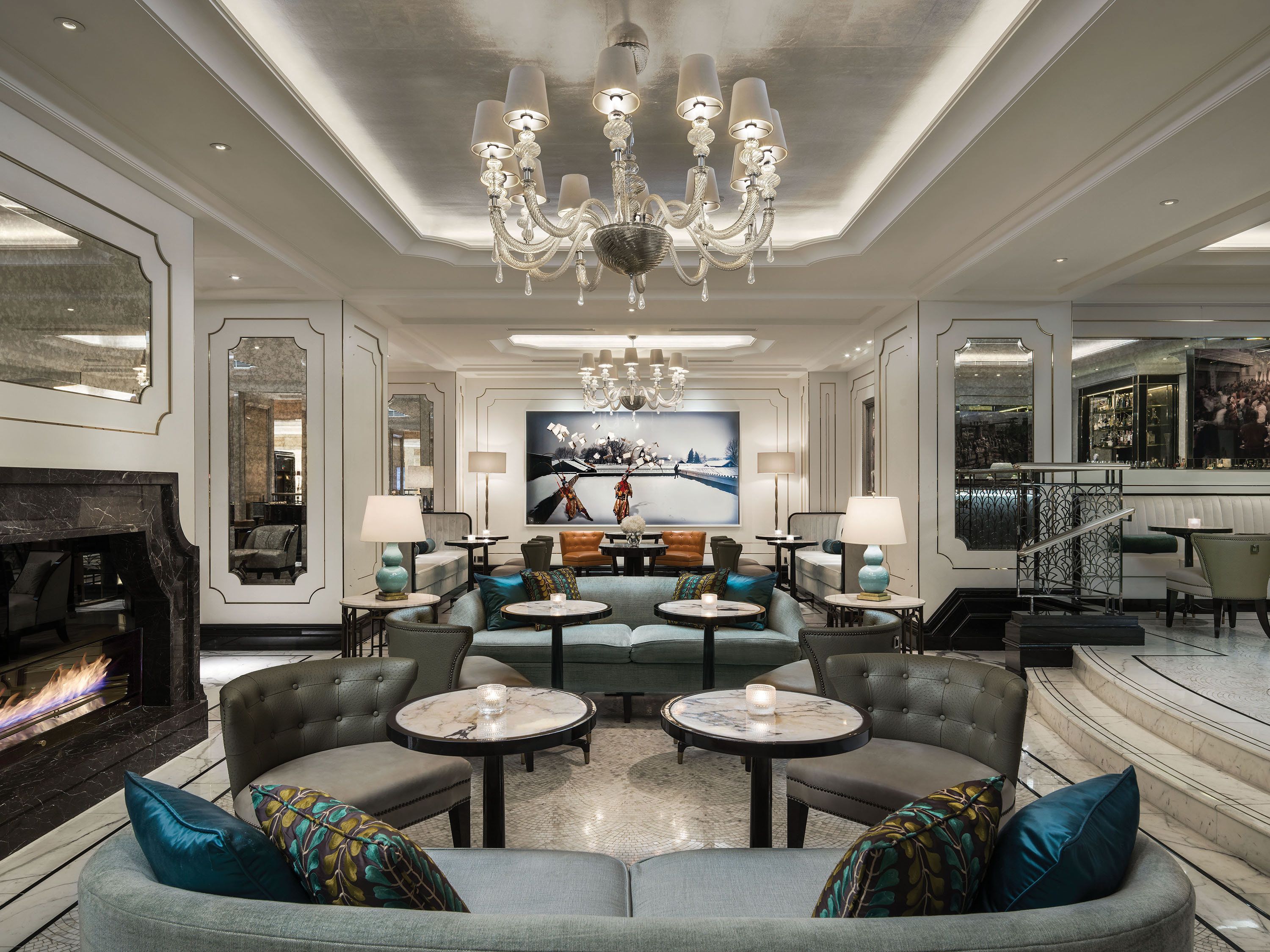 A luxurious lounge area with a fireplace, seating arrangements, and a bar.