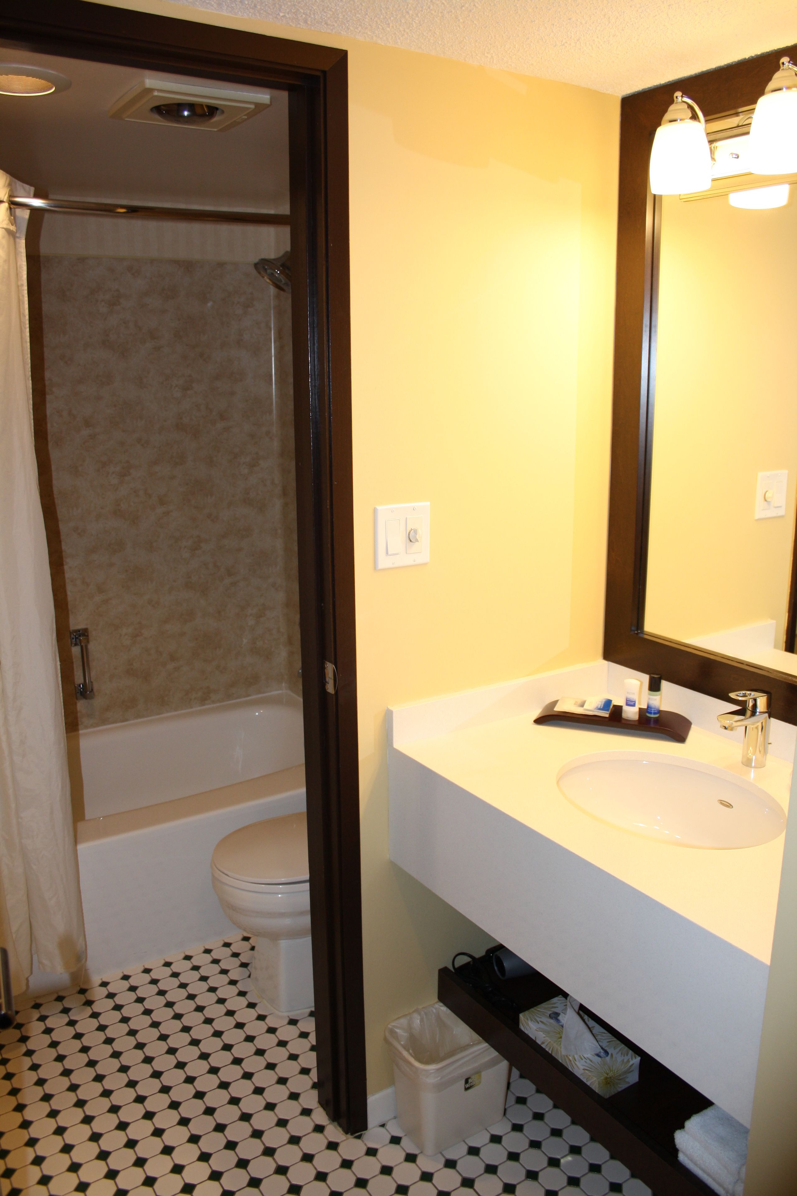 A bathroom with a bathtub, toilet, and sink.