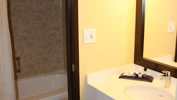 A bathroom with a bathtub, toilet, and sink.