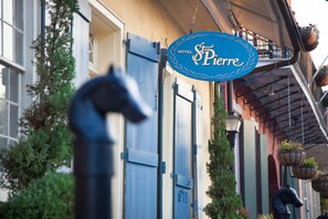 A hotel sign with the name "Hotel Pierre" and a horse statue in front. - Hotel St. Pierre®, a French Quarter Inns® Hotel (New Orleans)