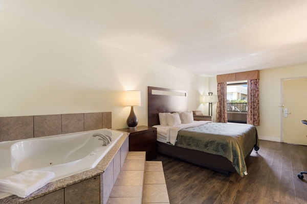 Room, 1 King Bed, Non Smoking, Jetted Tub | Desk, iron/ironing board, WiFi (free), alarm clocks