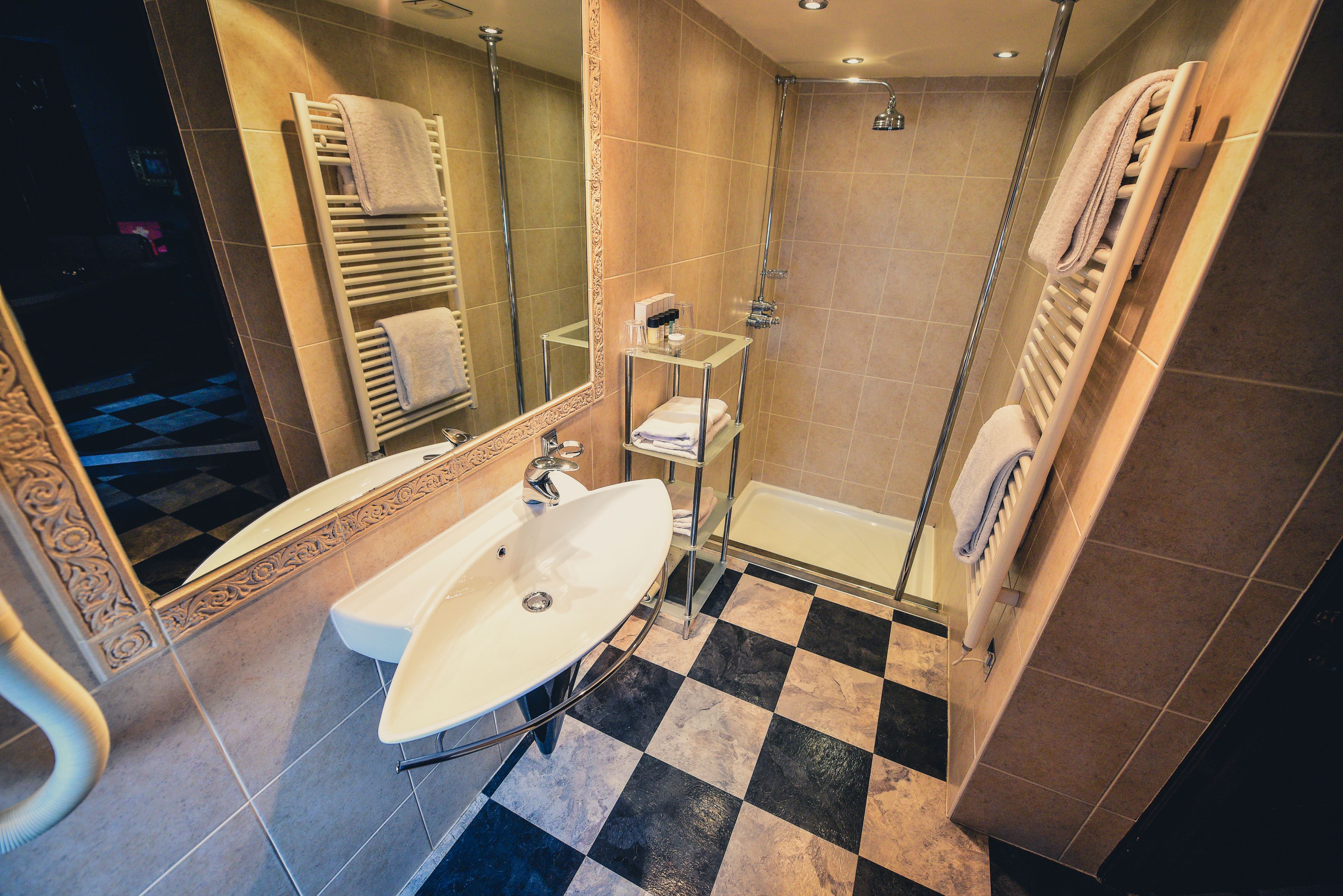 A modern bathroom with a large sink, a glass shower enclosure, and a bathtub.