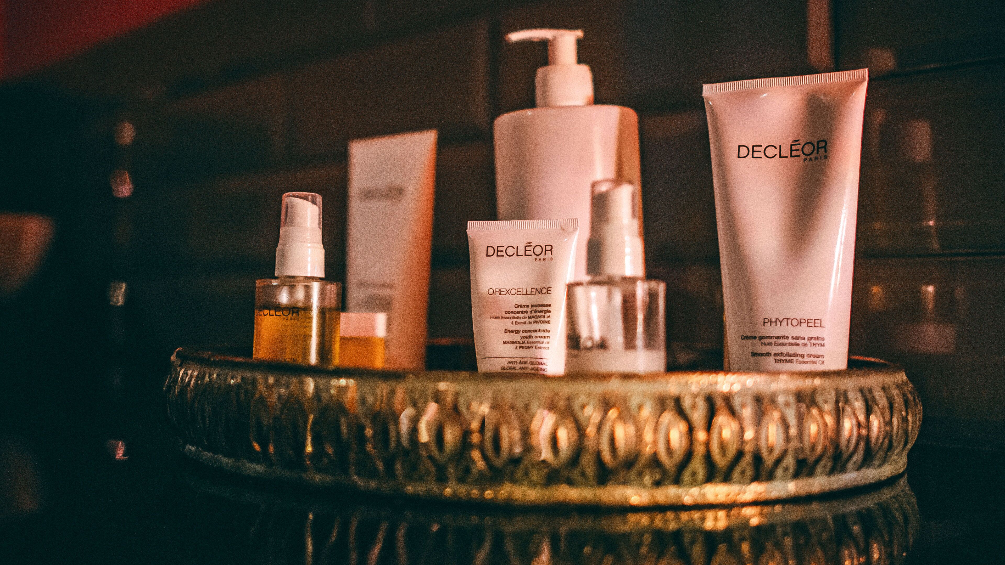 A selection of skincare products on a decorative tray.