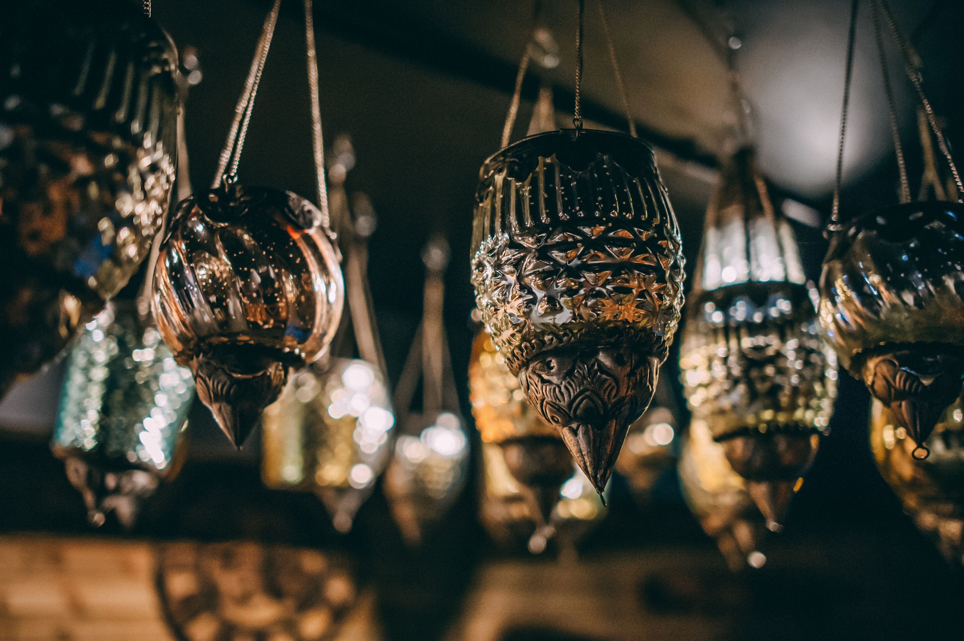 A collection of hanging glassware with intricate designs.
