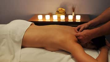 Experience a rejuvenating massage on a comfortable table, surrounded by soothing ambiance.