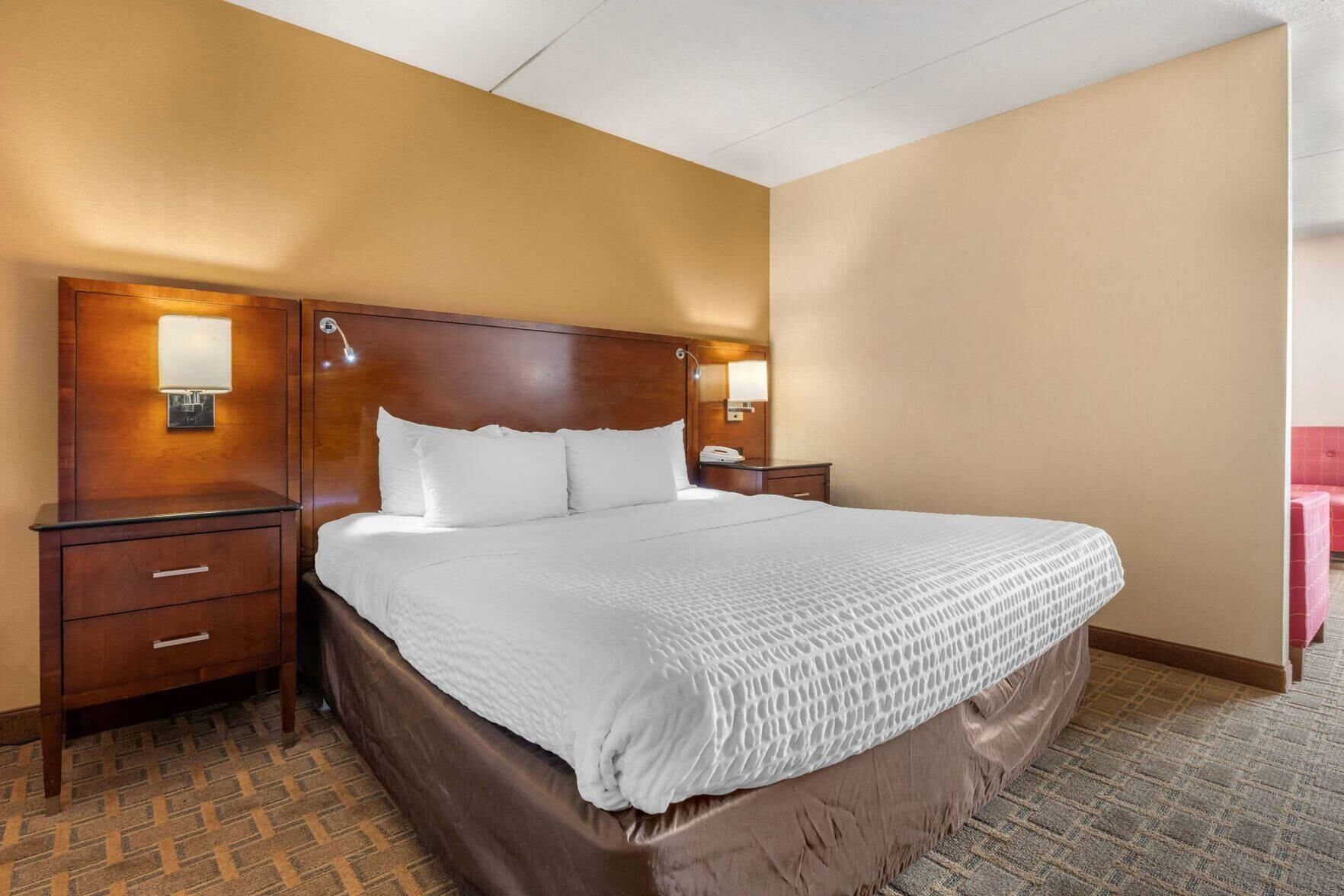 Premium bedding, desk, laptop workspace, blackout drapes
