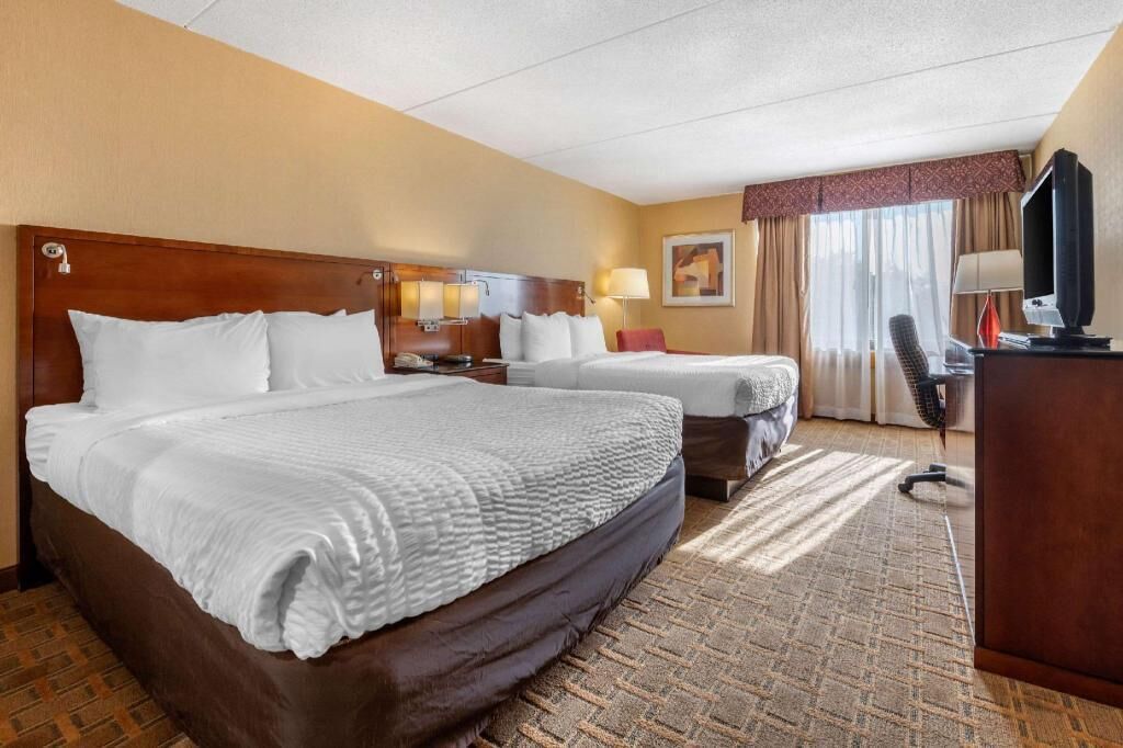 Premium bedding, desk, laptop workspace, blackout drapes