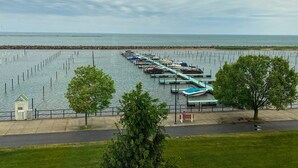 A marina with boats docked, a walking path, and a view of the water.