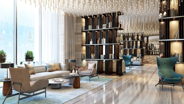 Un salon moderne comprenant un canapé, des fauteuils, une table basse et une bibliothèque.