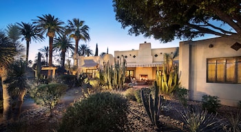 Relax in a tranquil courtyard surrounded by desert plants and a fire pit. at The Wigwam