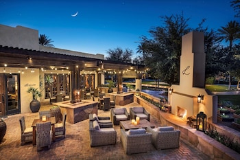 Relax in style with comfortable wicker furniture and a cozy fireplace. at The Wigwam