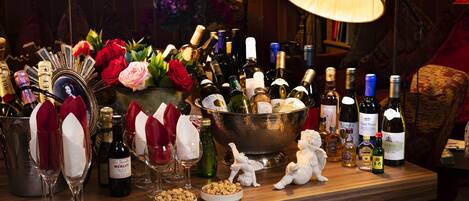 A bar area with a variety of bottles, glasses, and decorative items.