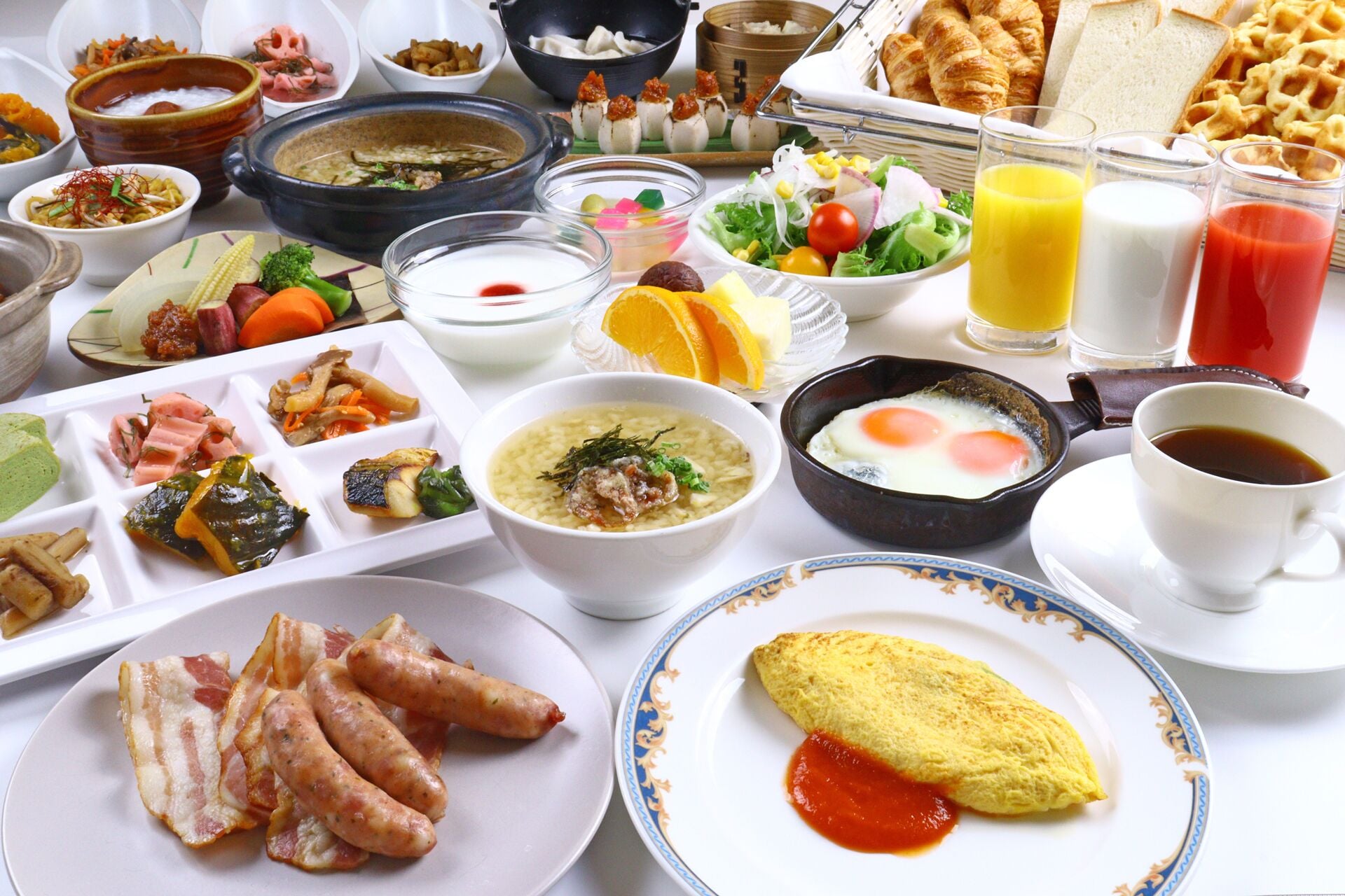 A variety of breakfast dishes including eggs, sausages, and soup.