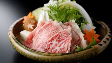 A bowl of sashimi with various garnishes.