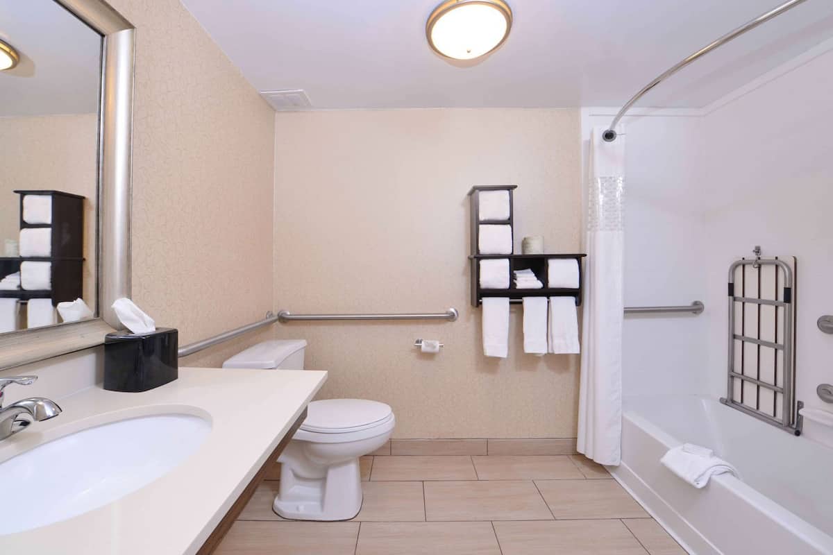A bathroom with a sink, toilet, and shower.